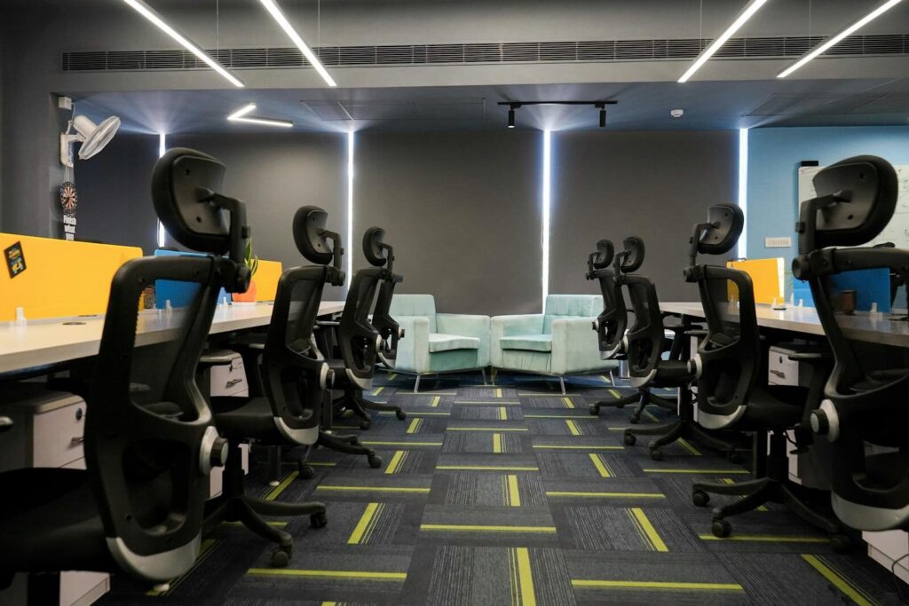 Spacious modern office with ergonomic chairs and bright decor, perfect for a productive work environment.